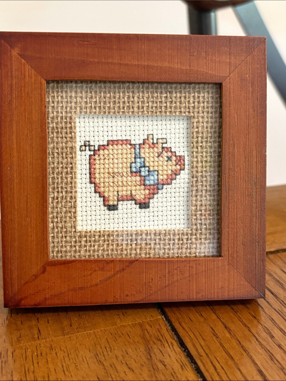 Embroidered Piglet Cross-Stitch Décor in Tan with Blue Bow